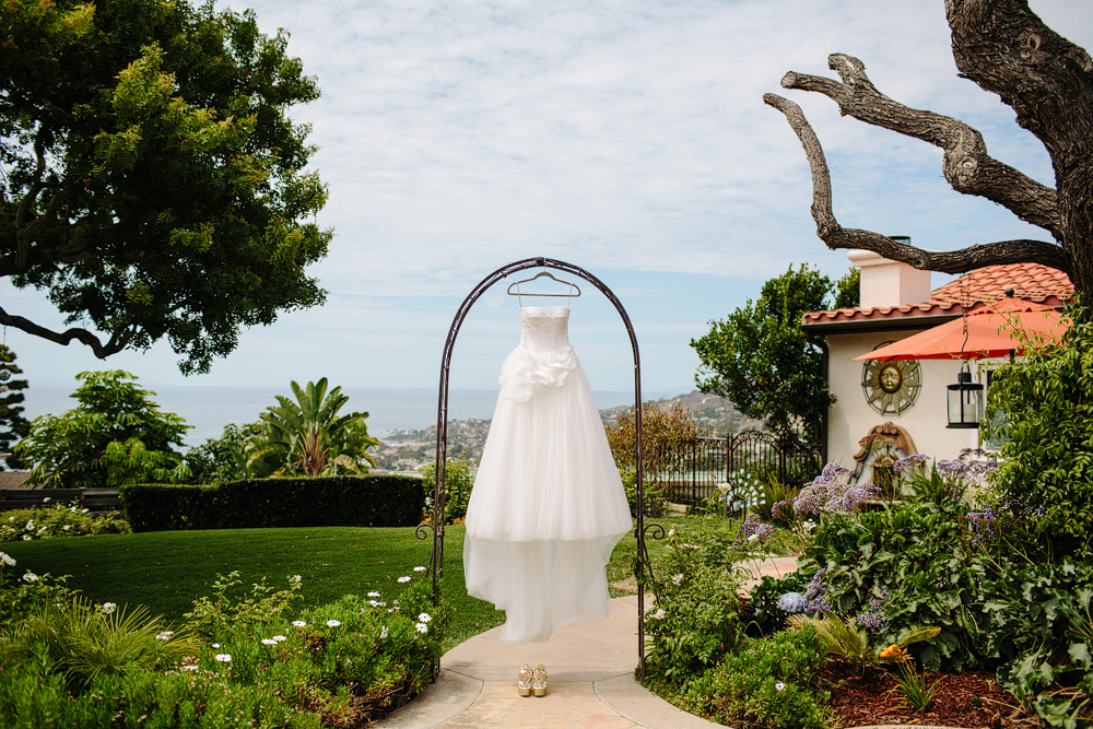 This is a photo of a dress hanging in an archway.