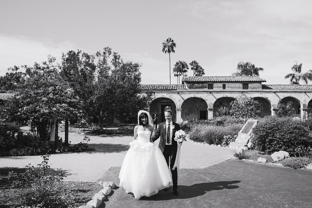 This is a cute candid moment of the bride and groom walking together.