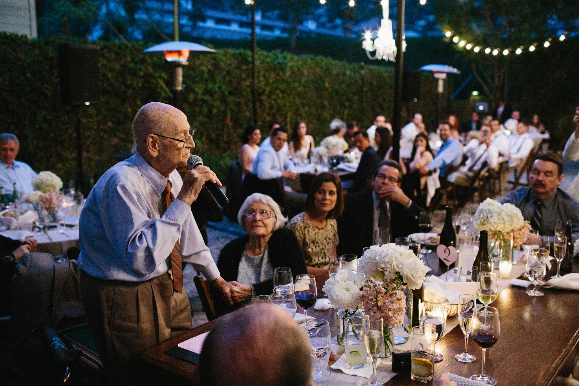 A grandfather gave a speech at the reception. 