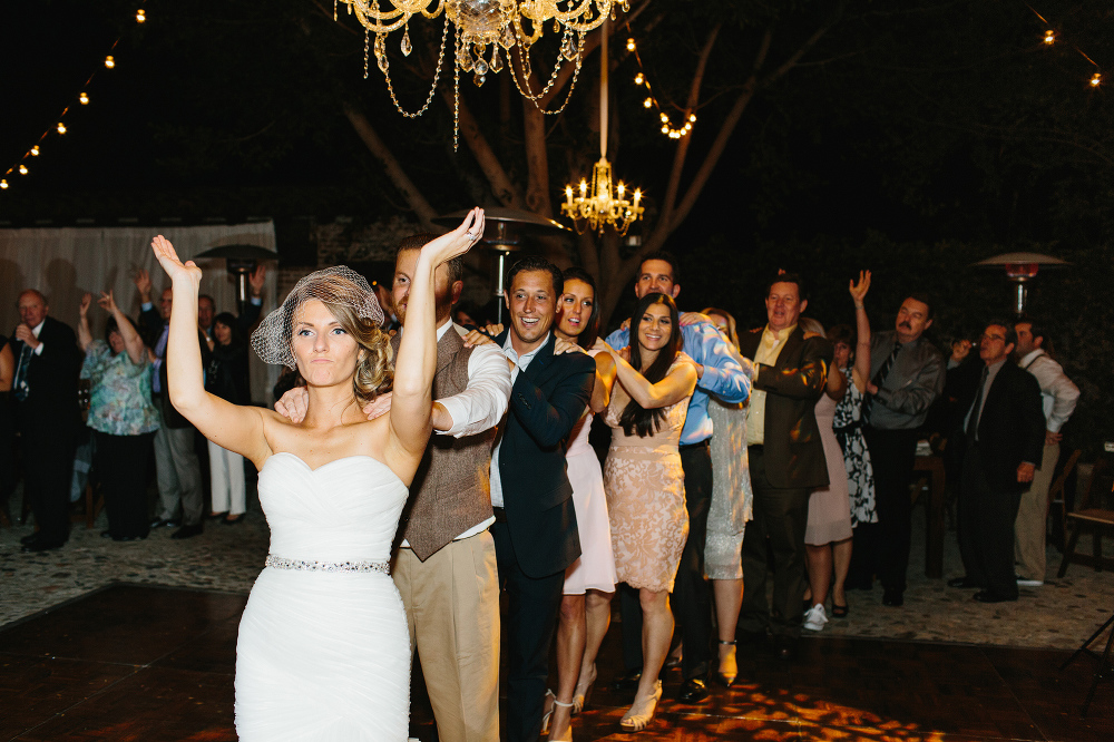 The bride dancing and leading the conga line. 