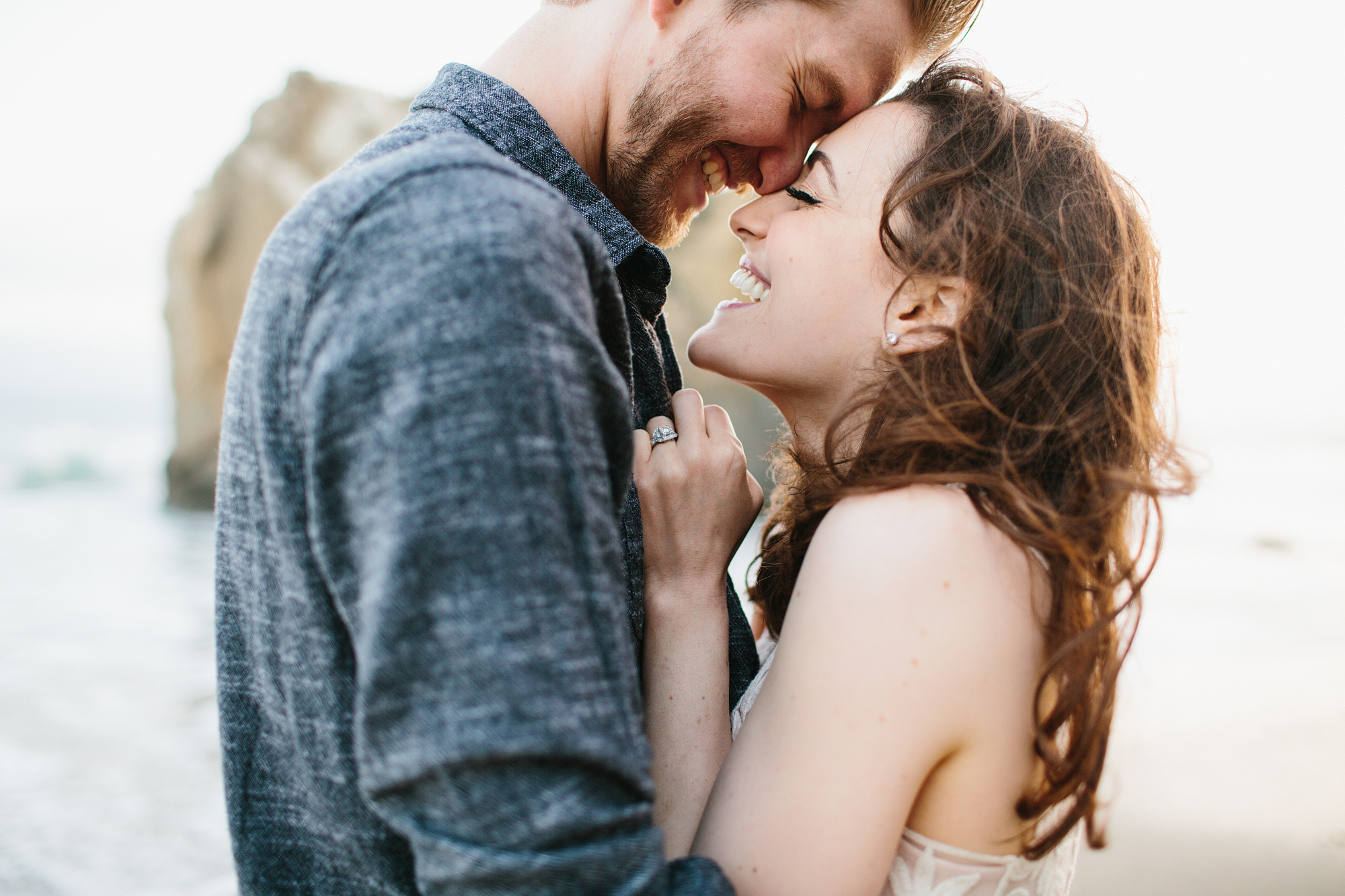 This is a cute photo of the couple smiling and laughing at the Malibu beach. 