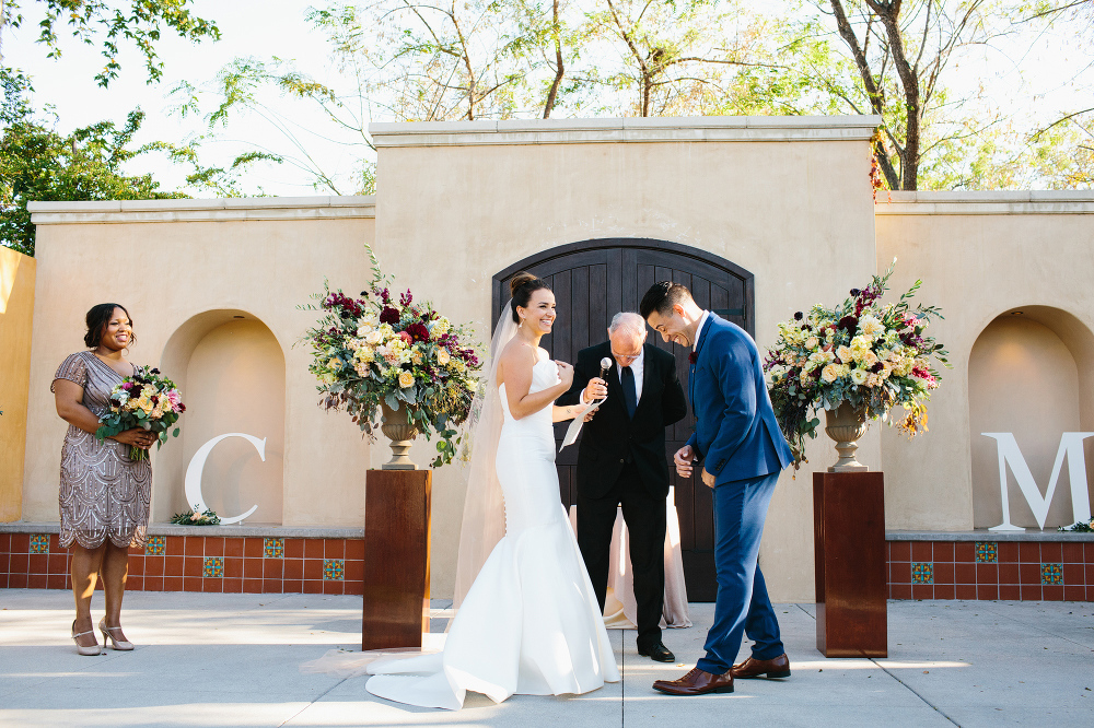 Here is a cute image of the bride and groom laughing during their wedding ceremony. 