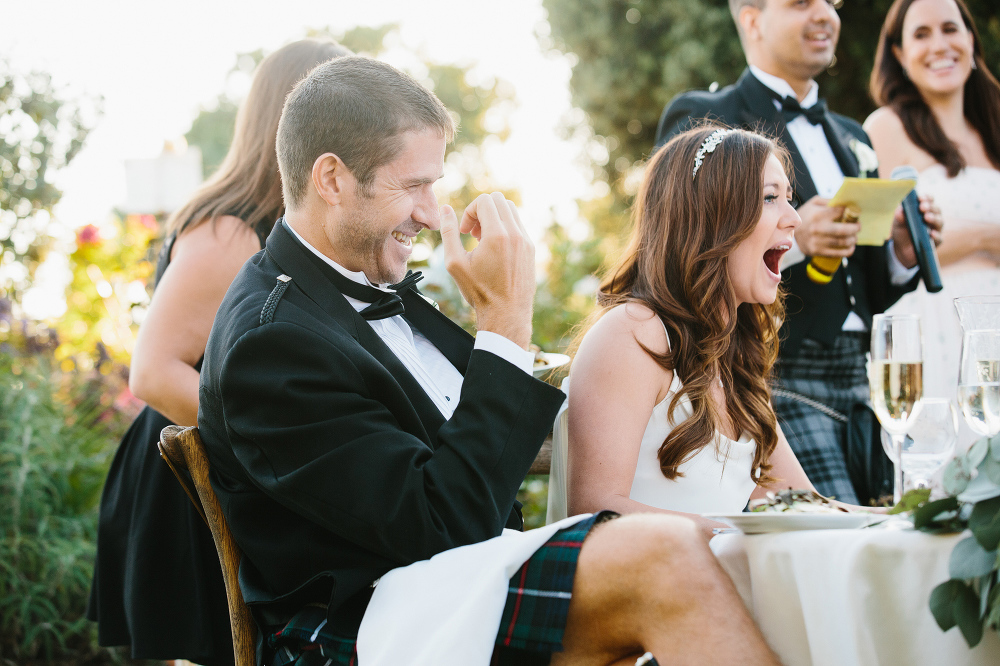 Jessica and Colin laughing during toasts. 