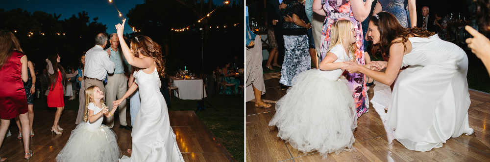 The bride dancing with a flower girl. 