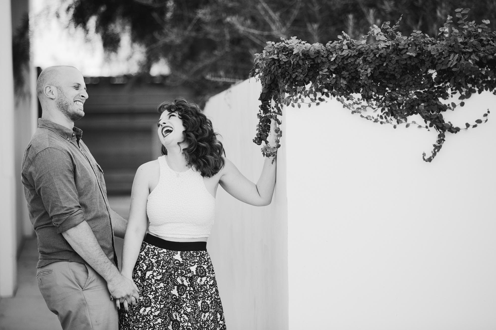 A black and white photo of the couple laughing. 