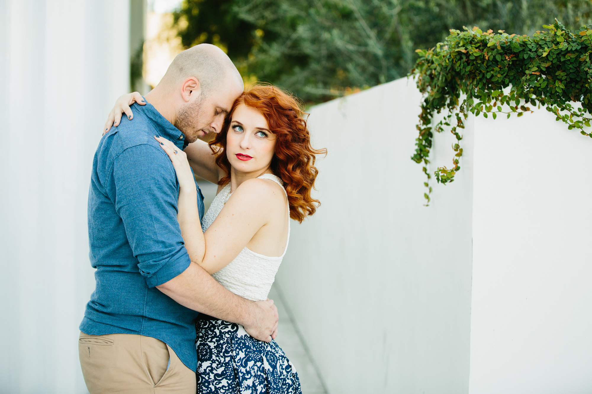 The bride wore a blue and white skirt with a white tank top. 