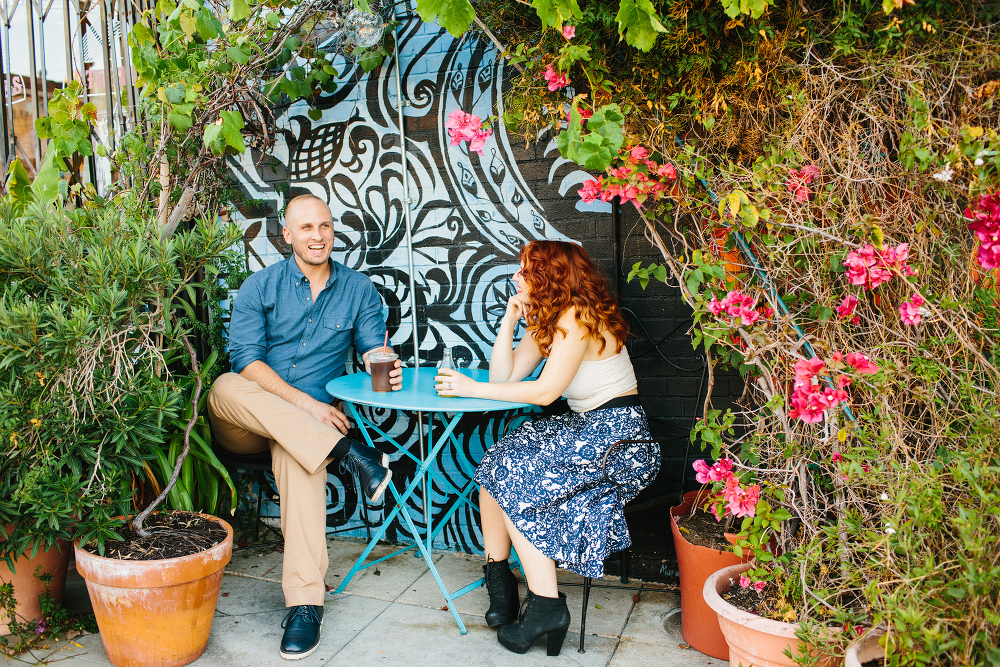 Afton and Jesse talking by a mural wall.