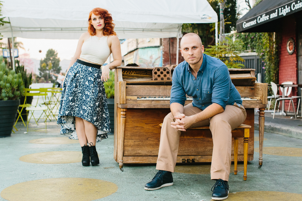 Afton and Jesse by a wood piano. 