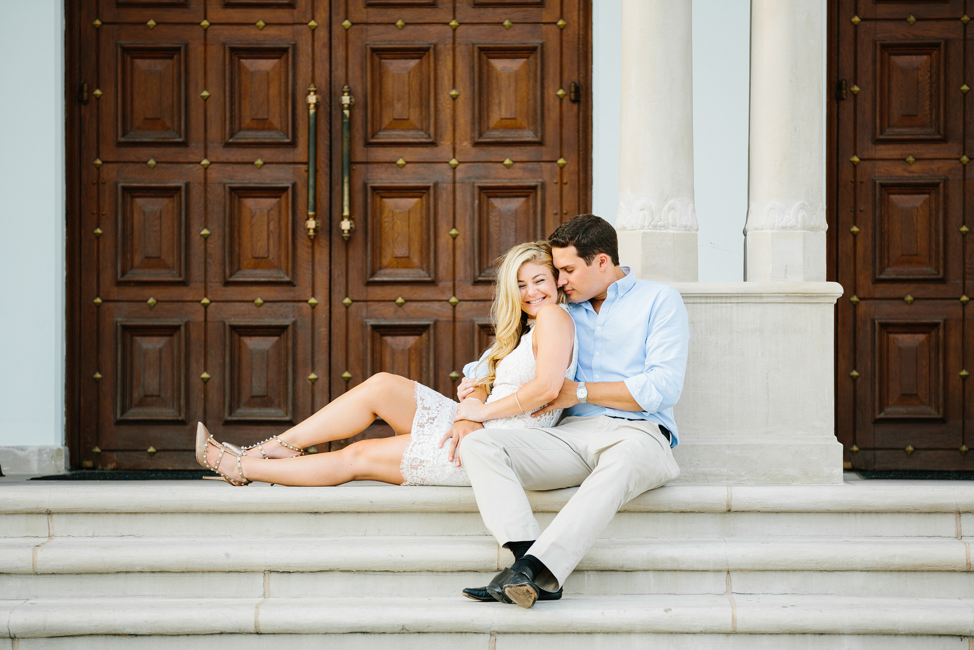 The couple sitting on steps. 