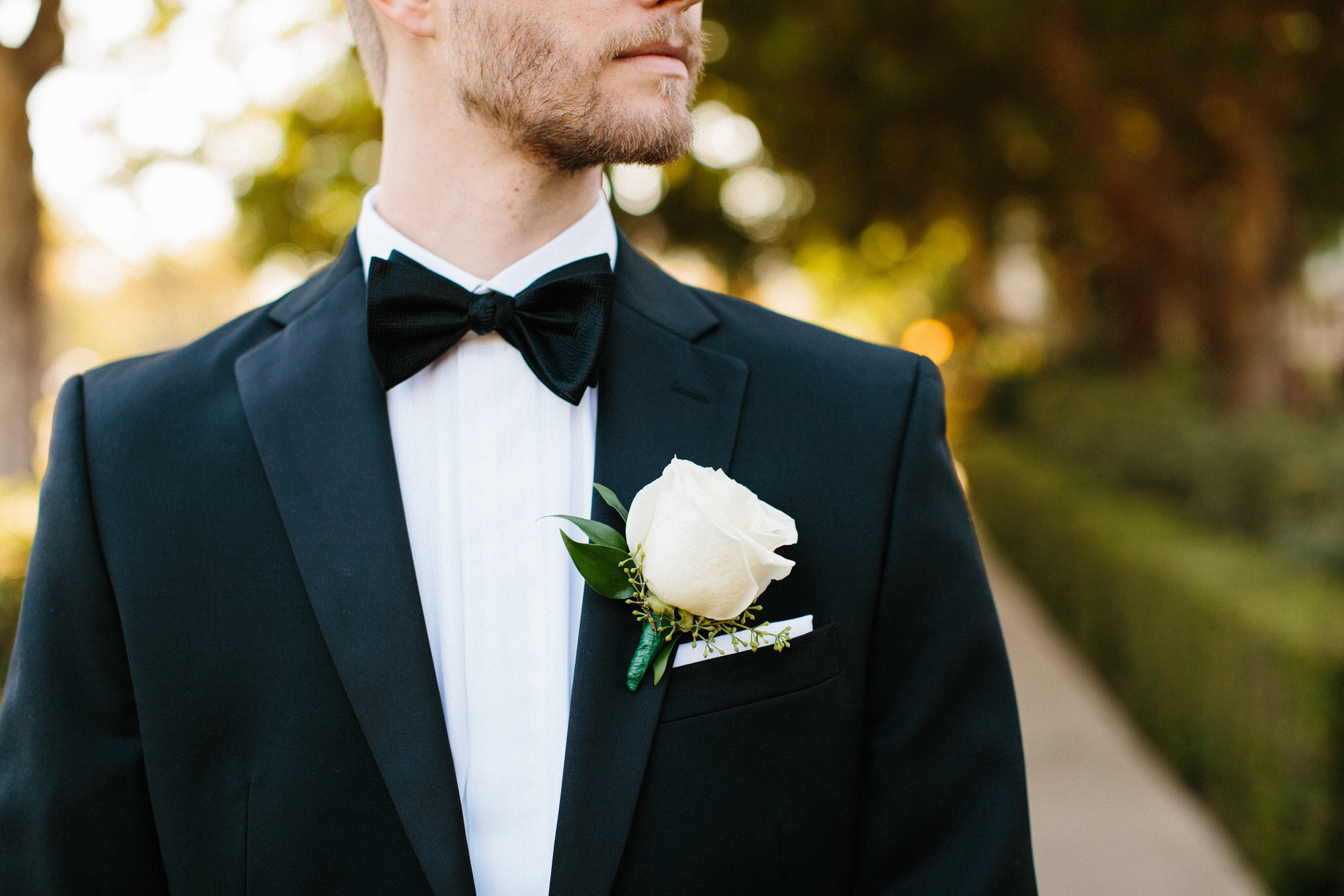 Karl had a white rose boutonniere. 