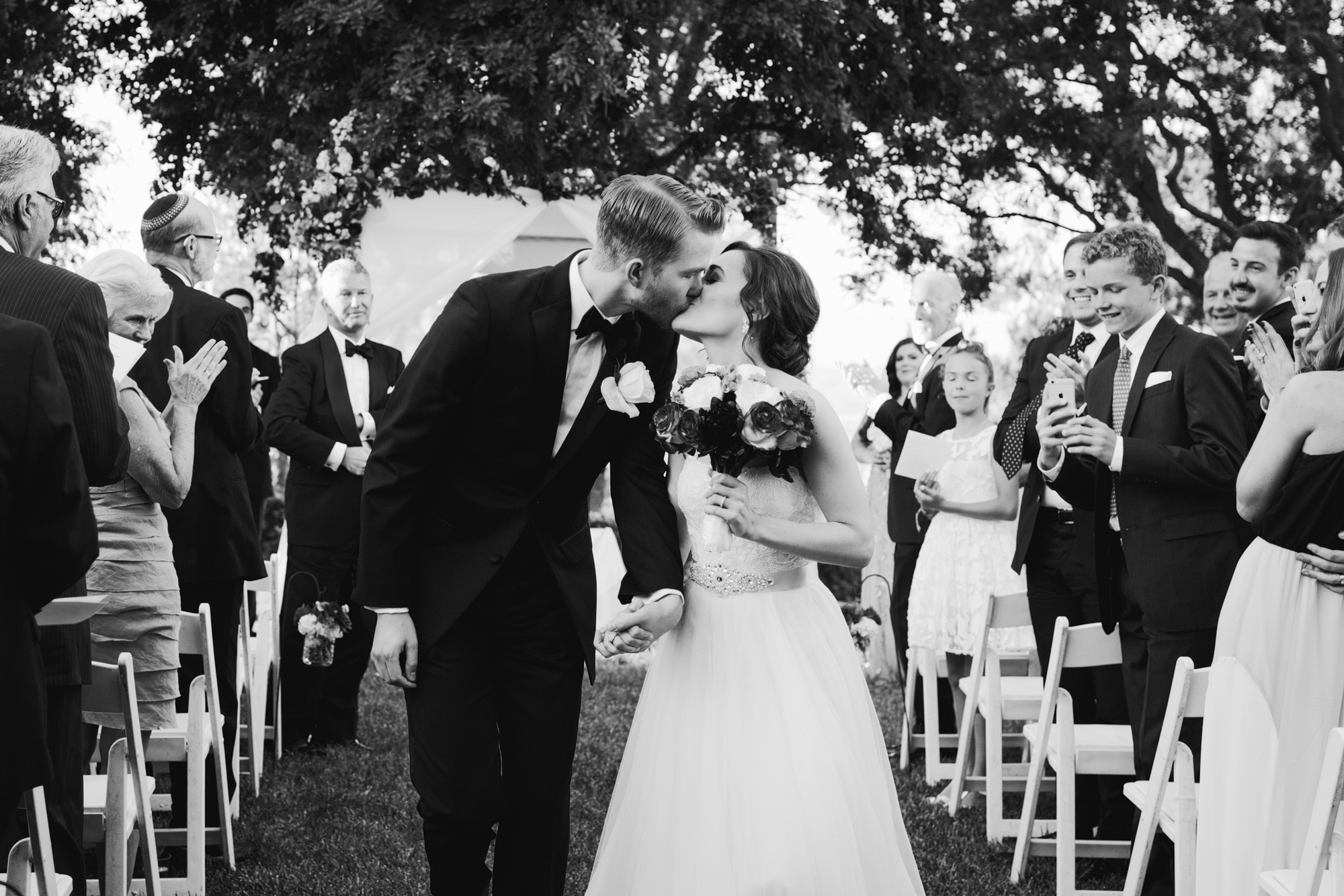 The couple walking down the aisle as husband and wife. 