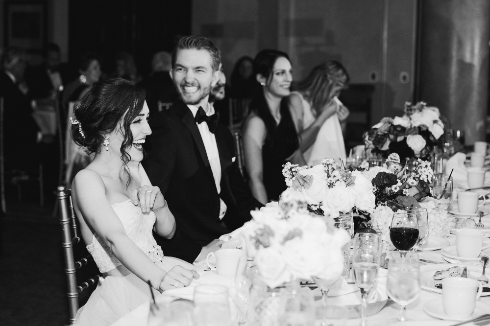 Laura and Karl laughing during toasts. 