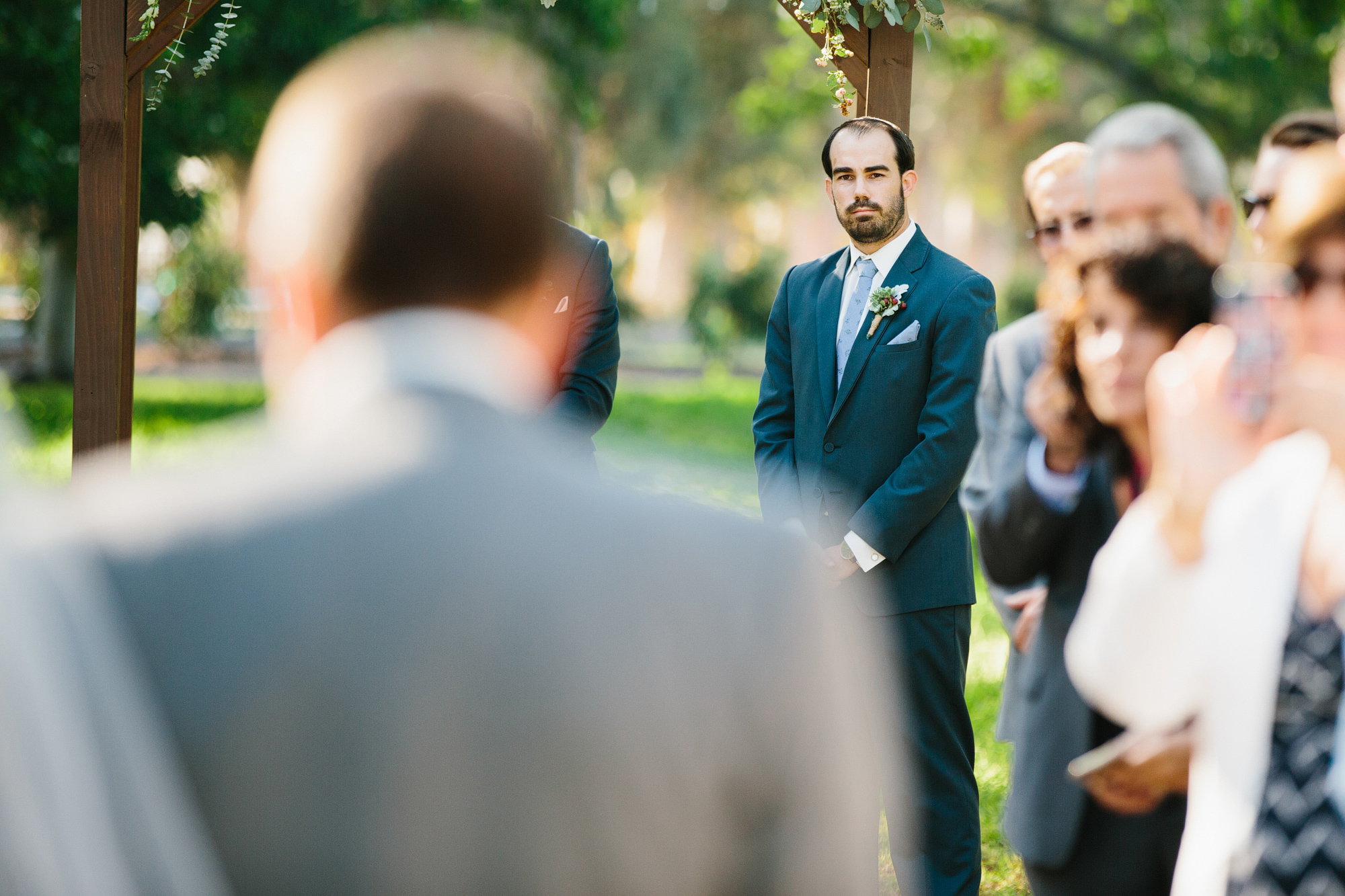 Chad waiting as Katie walks down the aisle. 