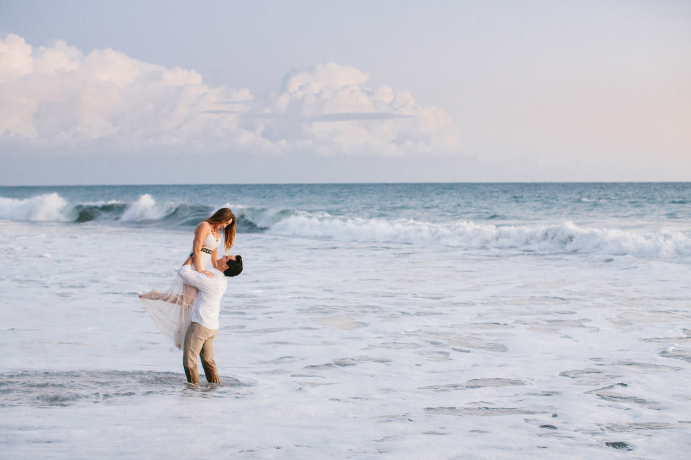 Steven holding Vanessa in the water. 