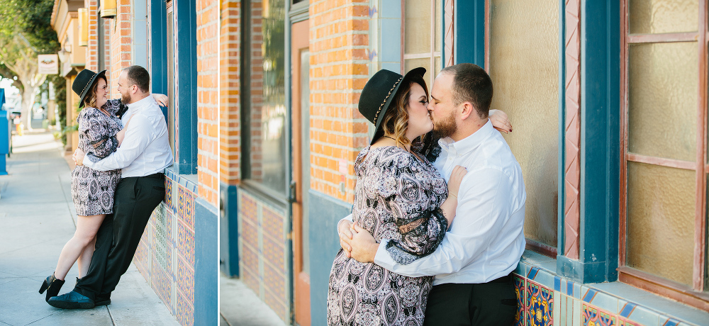 Amanda and Jason leaning on a brick and tile wall. 