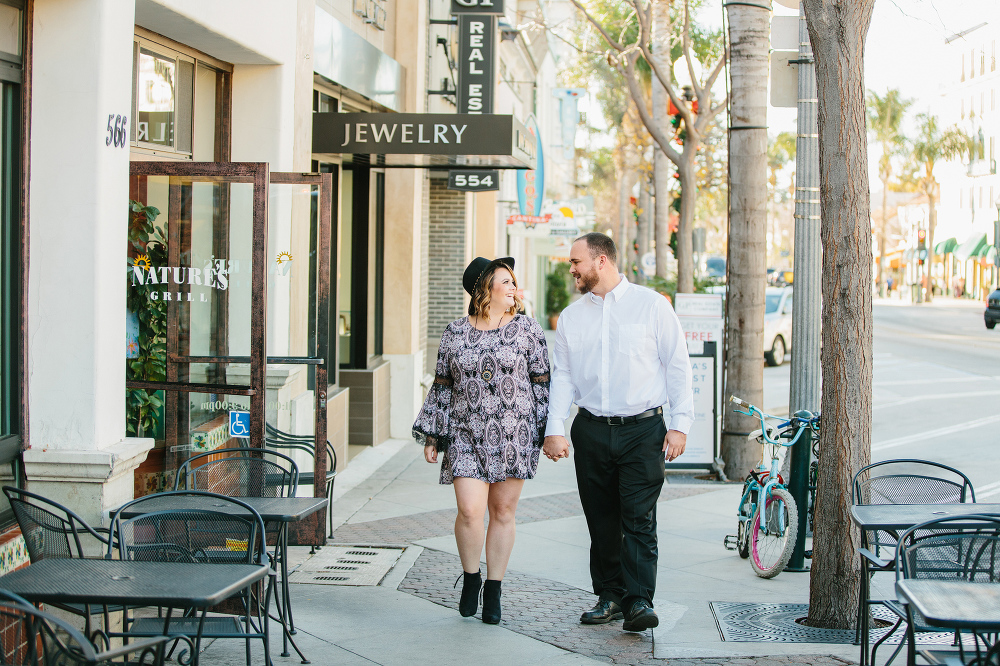 The couple walking down the street together. 