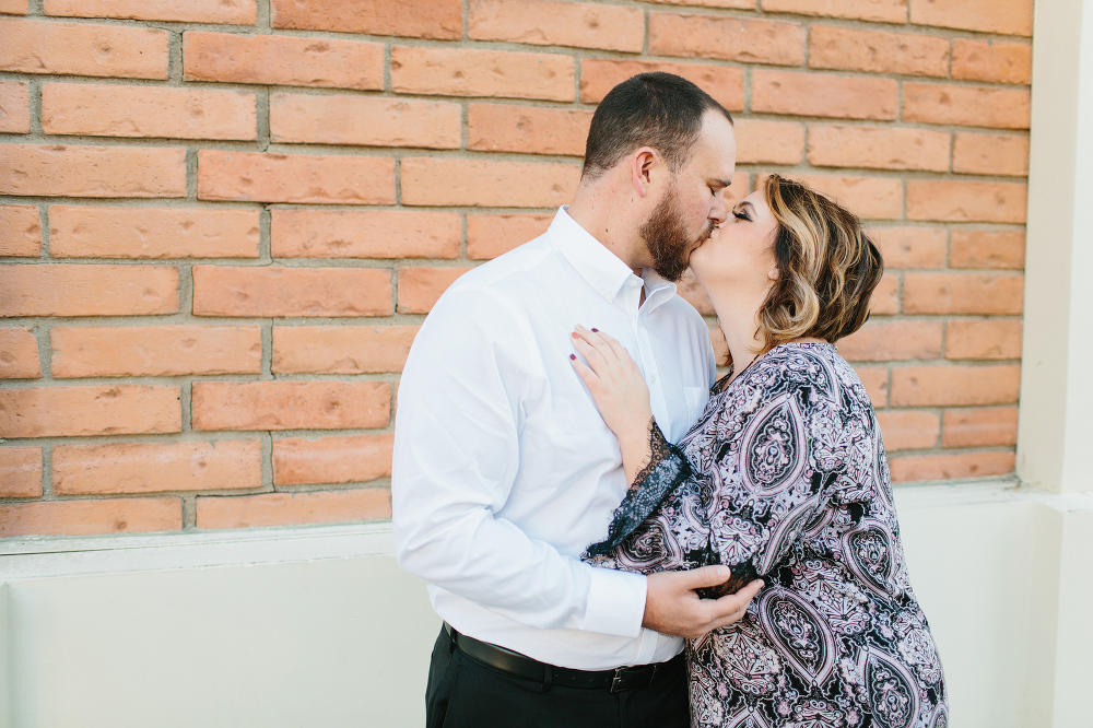 Jason and Amanda in front of a brick wall. 