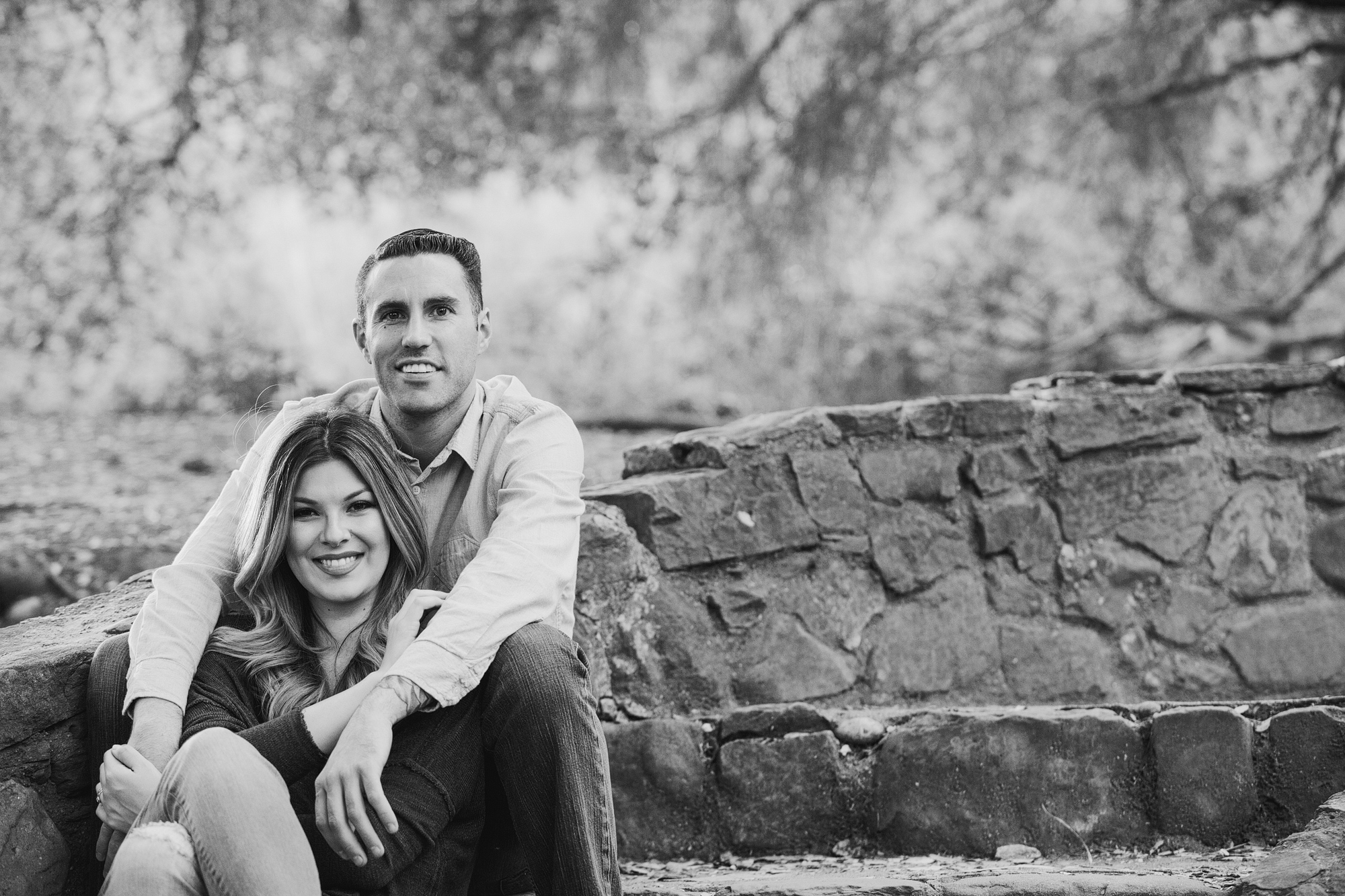 Nikki and Derrick sitting on stone steps. 