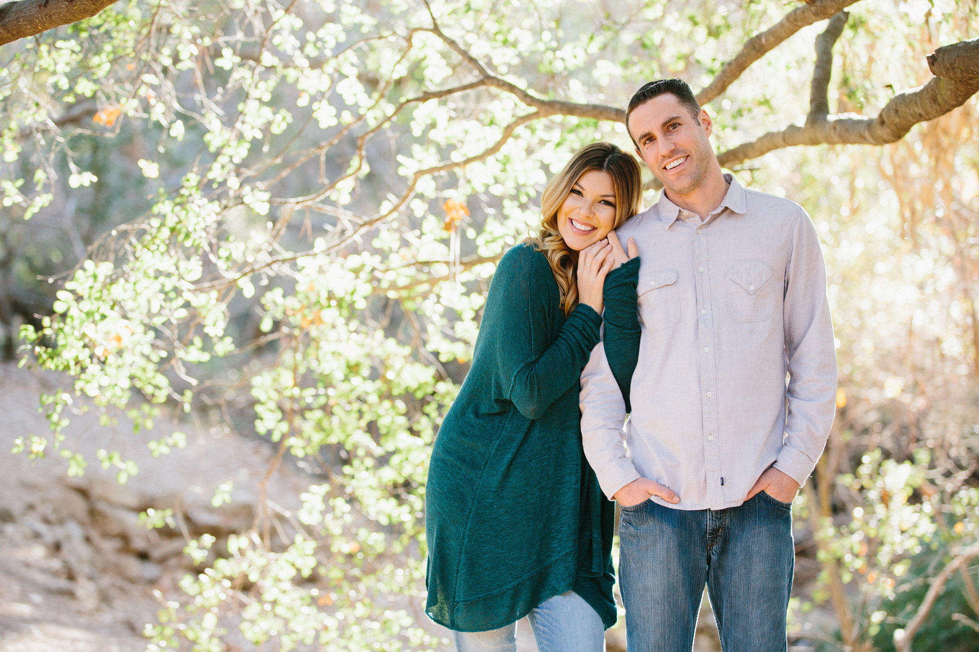 Nikki and Derrick by a large tree. 