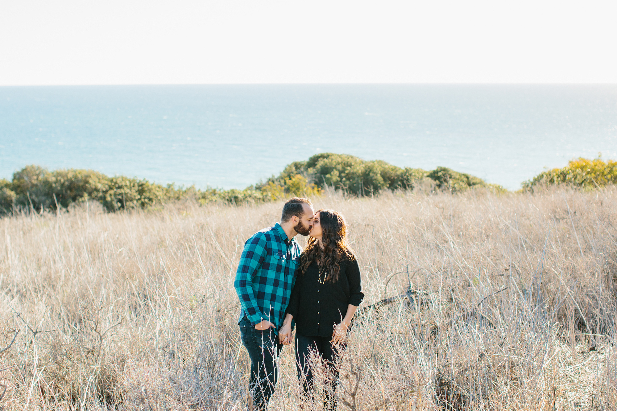 Desi and Curtis kissing in the fields. 