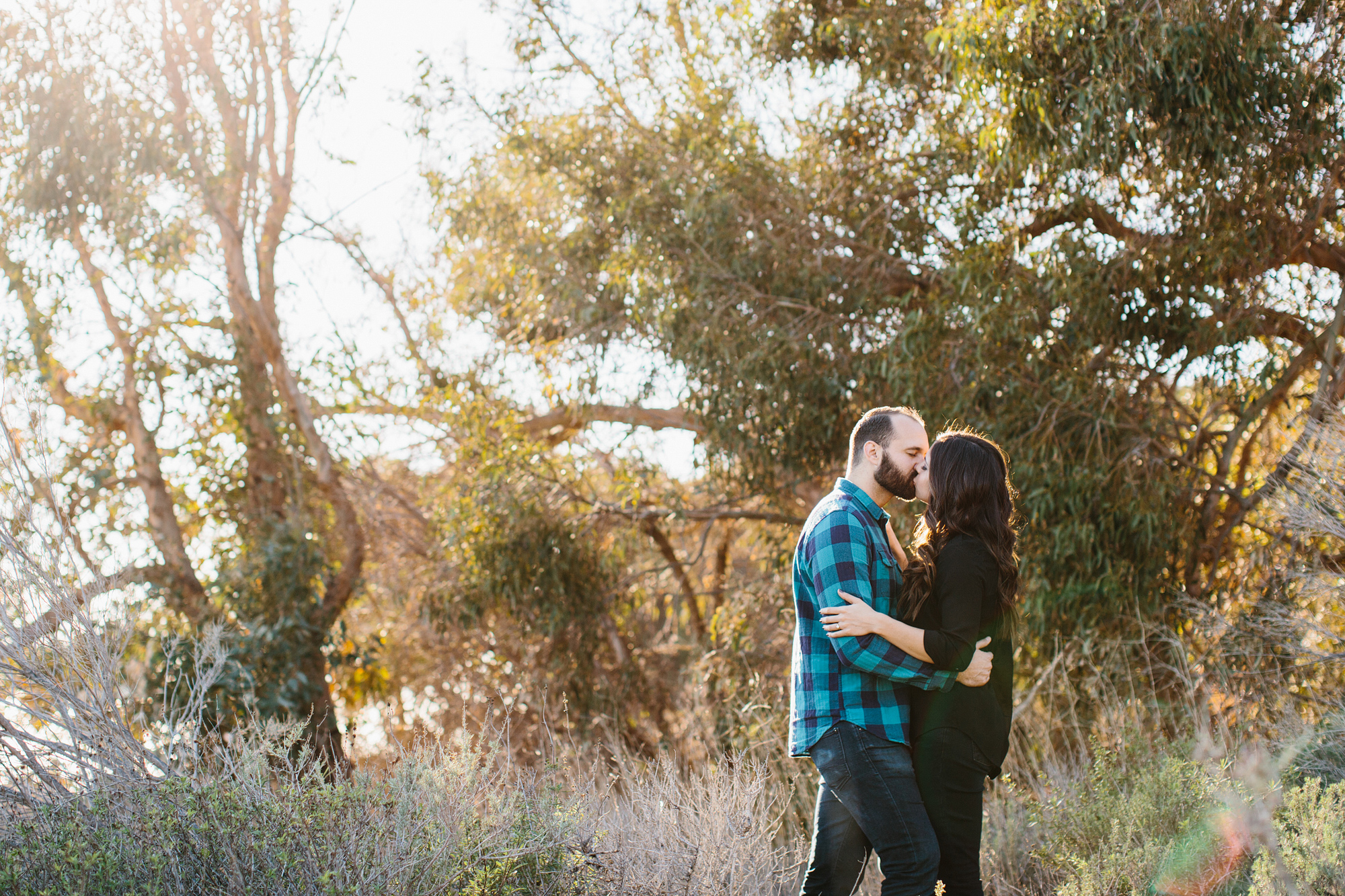 Desi and Curtis surrounded by trees. 