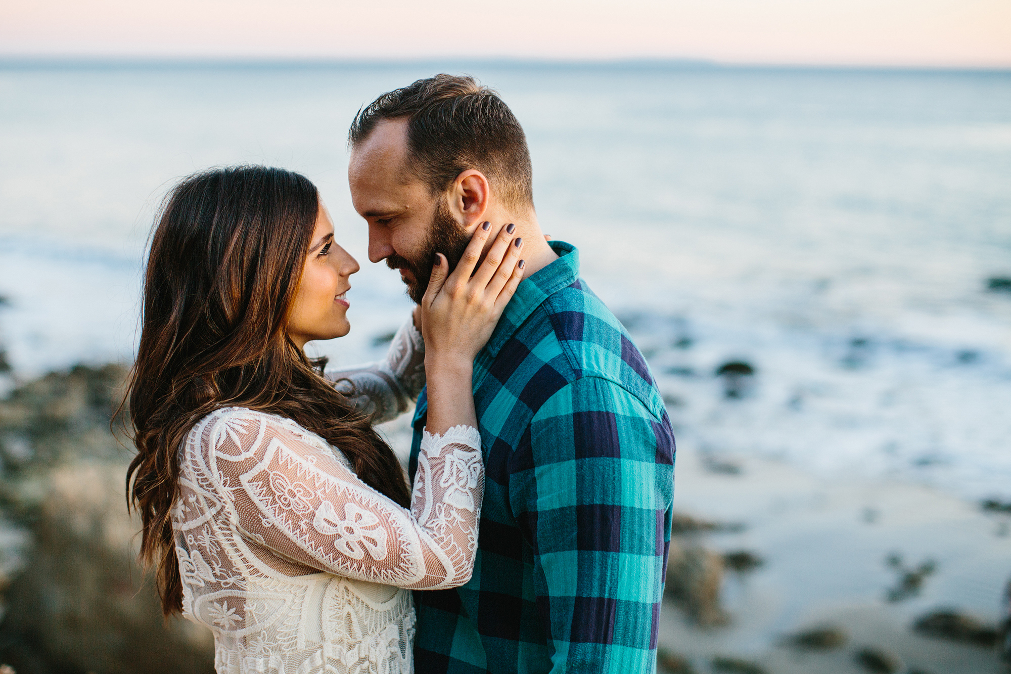 The couple with the beach in the background. 