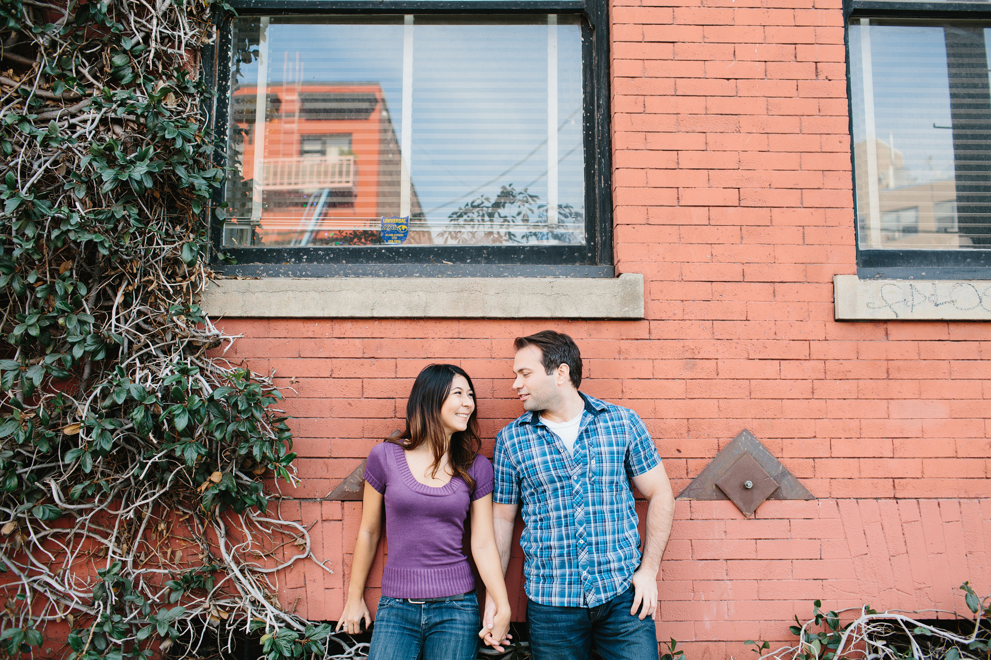 The couple standing under a window. 