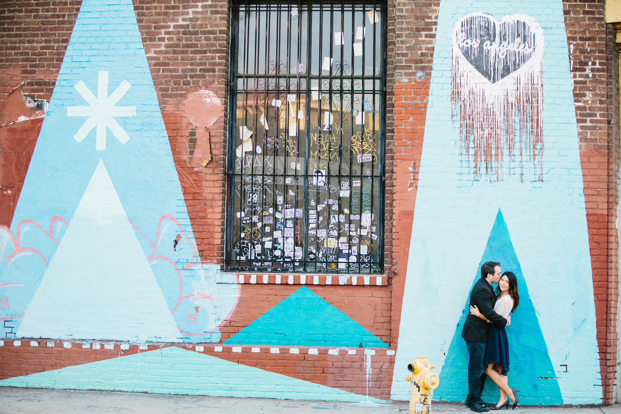 Janice and Mike in front of a graffiti wall. 