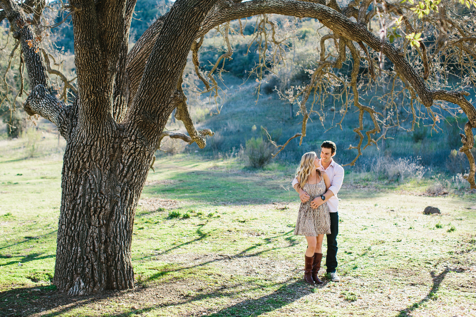 The couple under a large tree. 