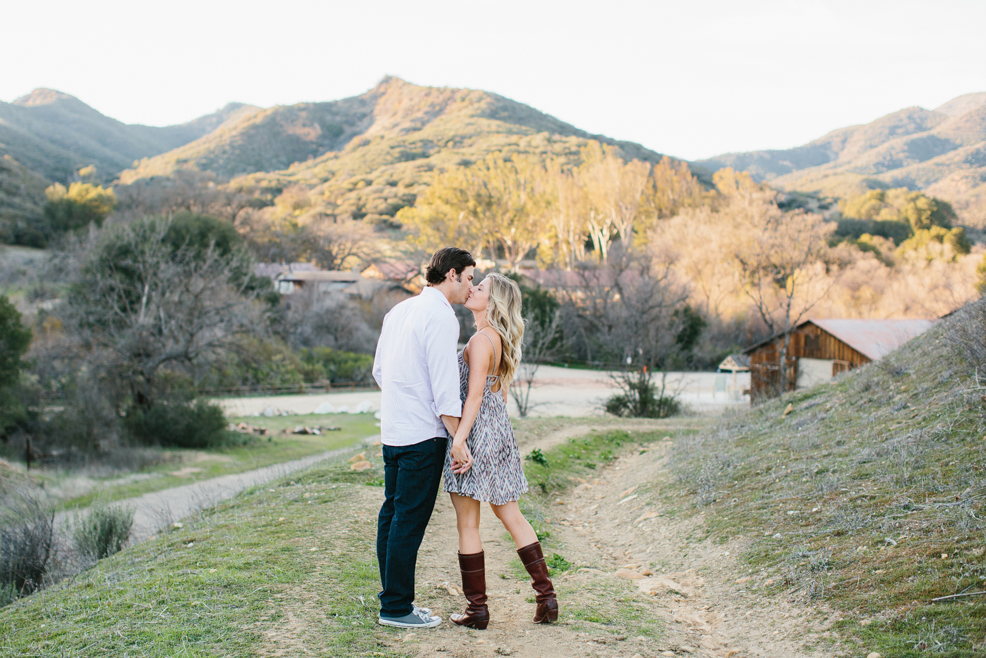 Megan and Travis walking on a dirt path. 